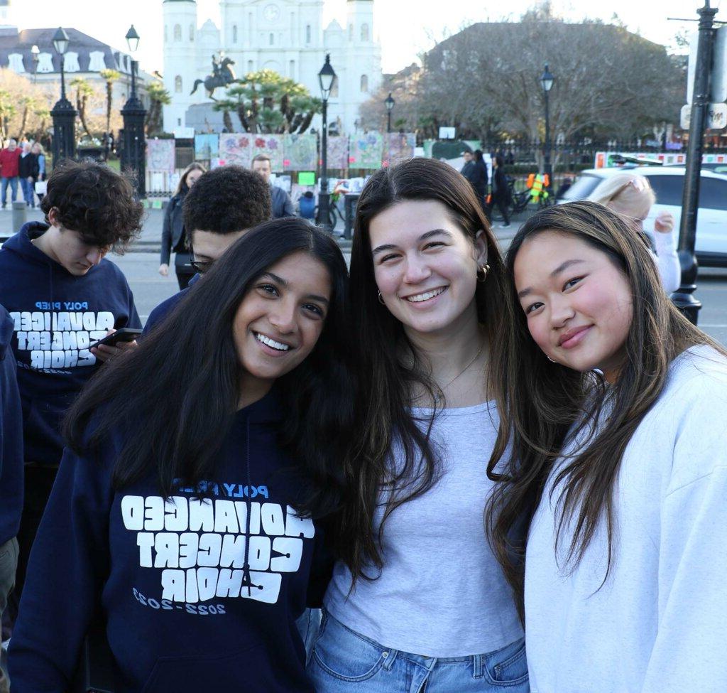 Poly Prep alumnae Francesca Corsalini ’22, Miranda Meyer ’22, and Anjali Budhram '24 of Advanced Concert Choir in front of Jackson Square, New Orleans 2023