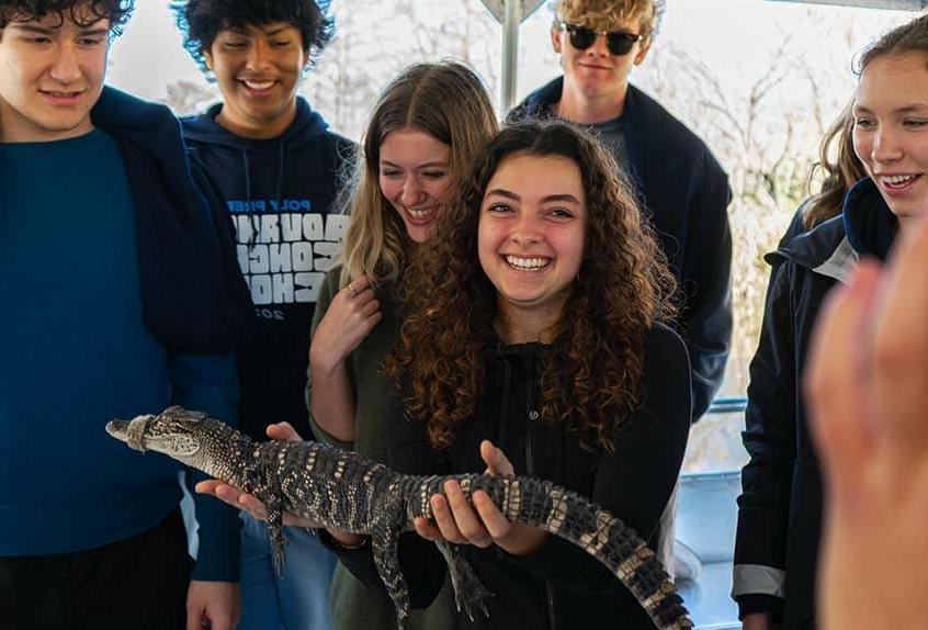 Advanced Concert Choir meets an alligator during swamp tour