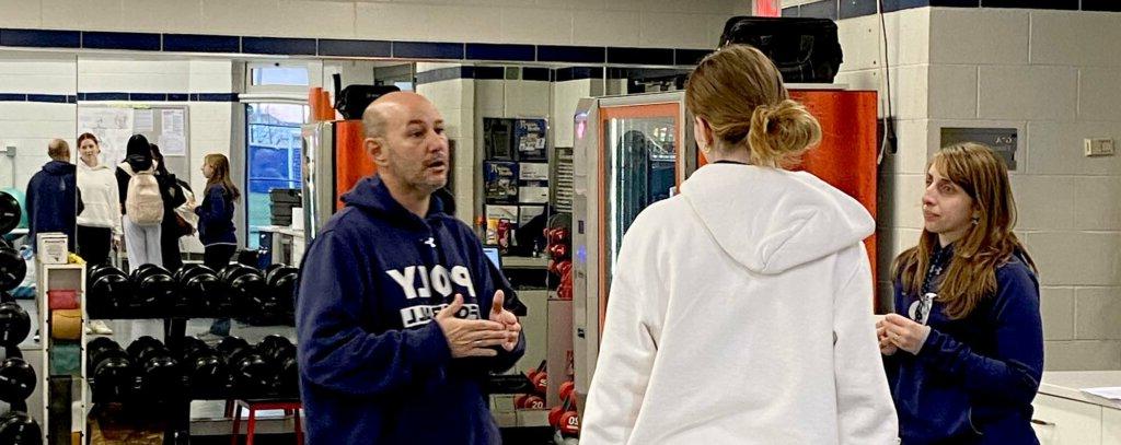 Athletic Trainera Alyssa Alaimo and John Pomponio talk to student