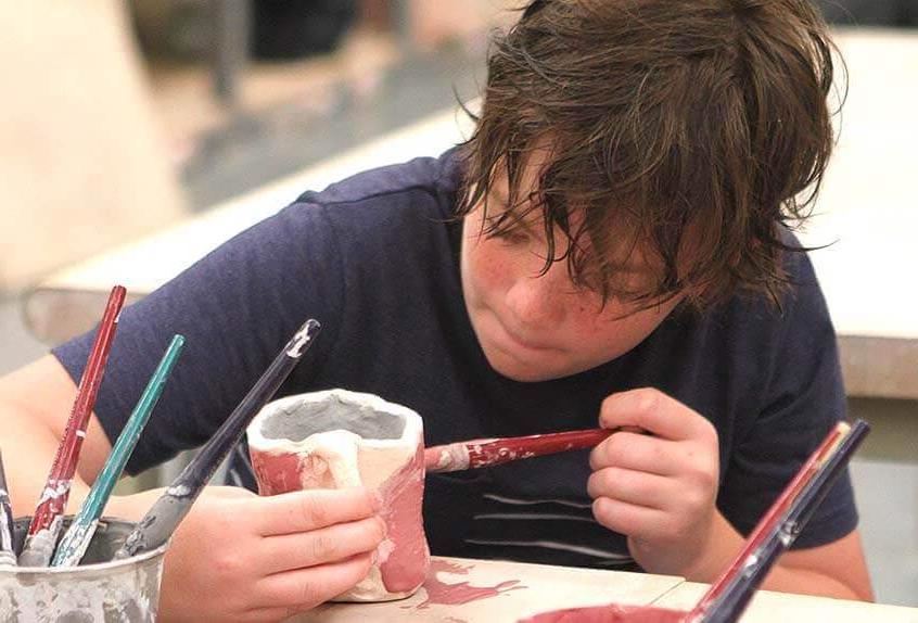 Boy doing ceramics at Poly Summer day camp